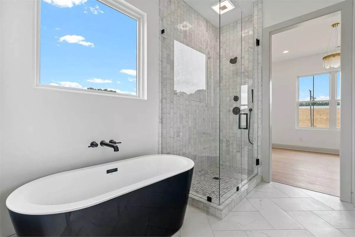 Matte Black Fixtures Earn Their Keep Against Marble Tile and a Freestanding Tub