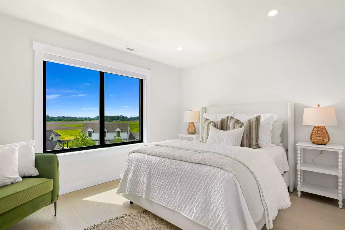 Bedroom With a View of Open Fields and Rooftops Worth Waking Up To