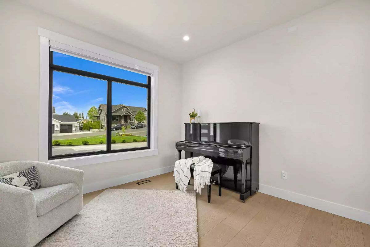 Black Piano Against White Walls Gives This Sitting Room Its Personality