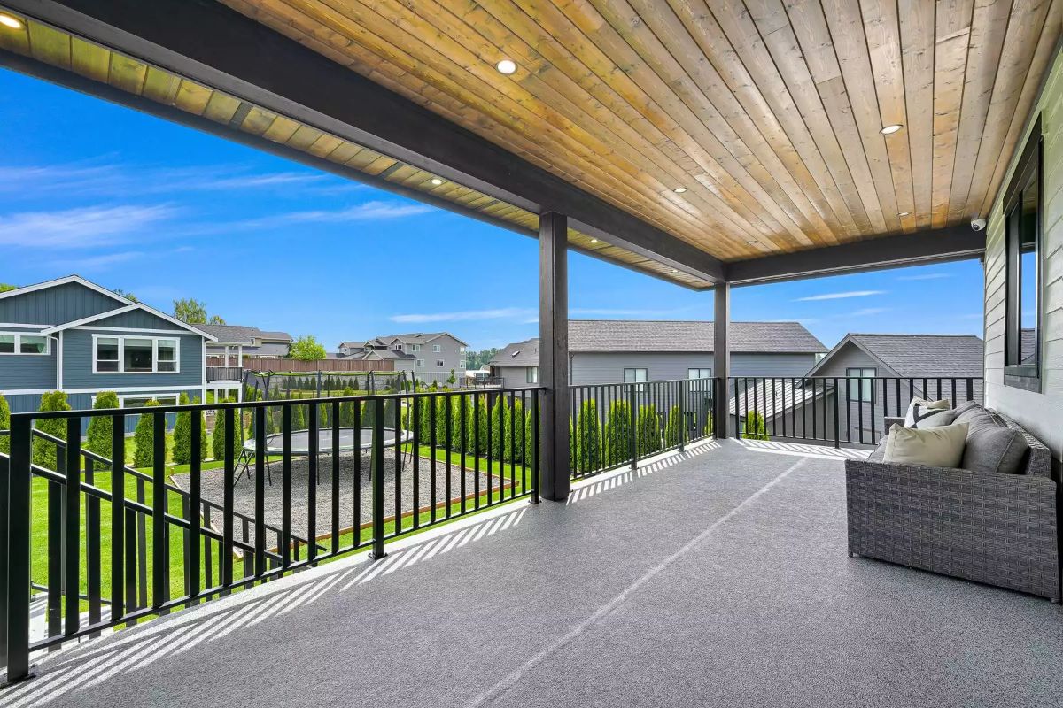 Covered Deck With a Wood-Plank Ceiling and Recessed Lights Built to Stay Outside