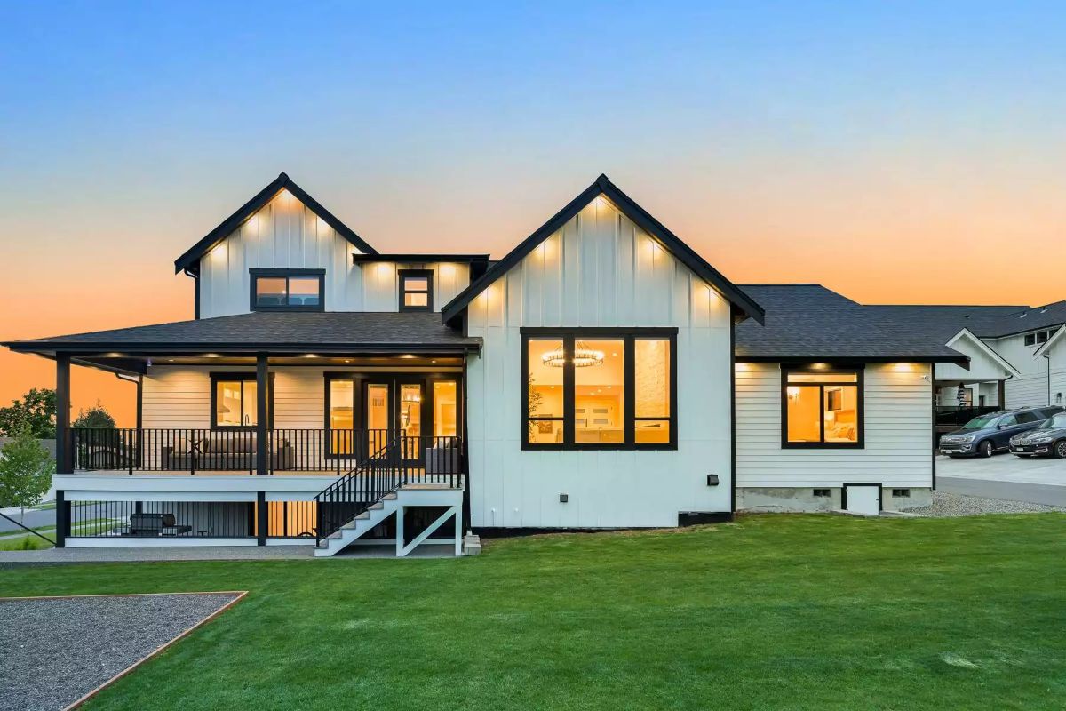 Covered Wrap Porch and Board-and-Batten Exterior Glowing at Dusk