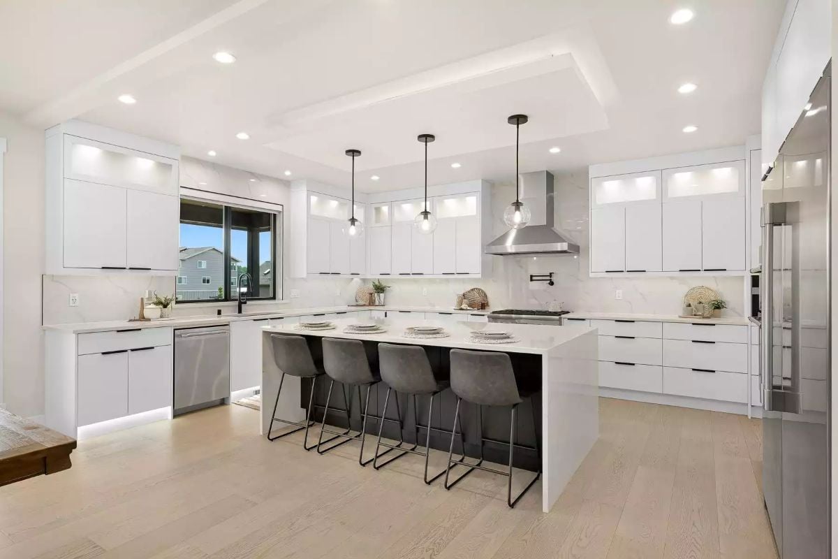 Pendant Lights Over a Waterfall Island Built to Handle Breakfast and Company