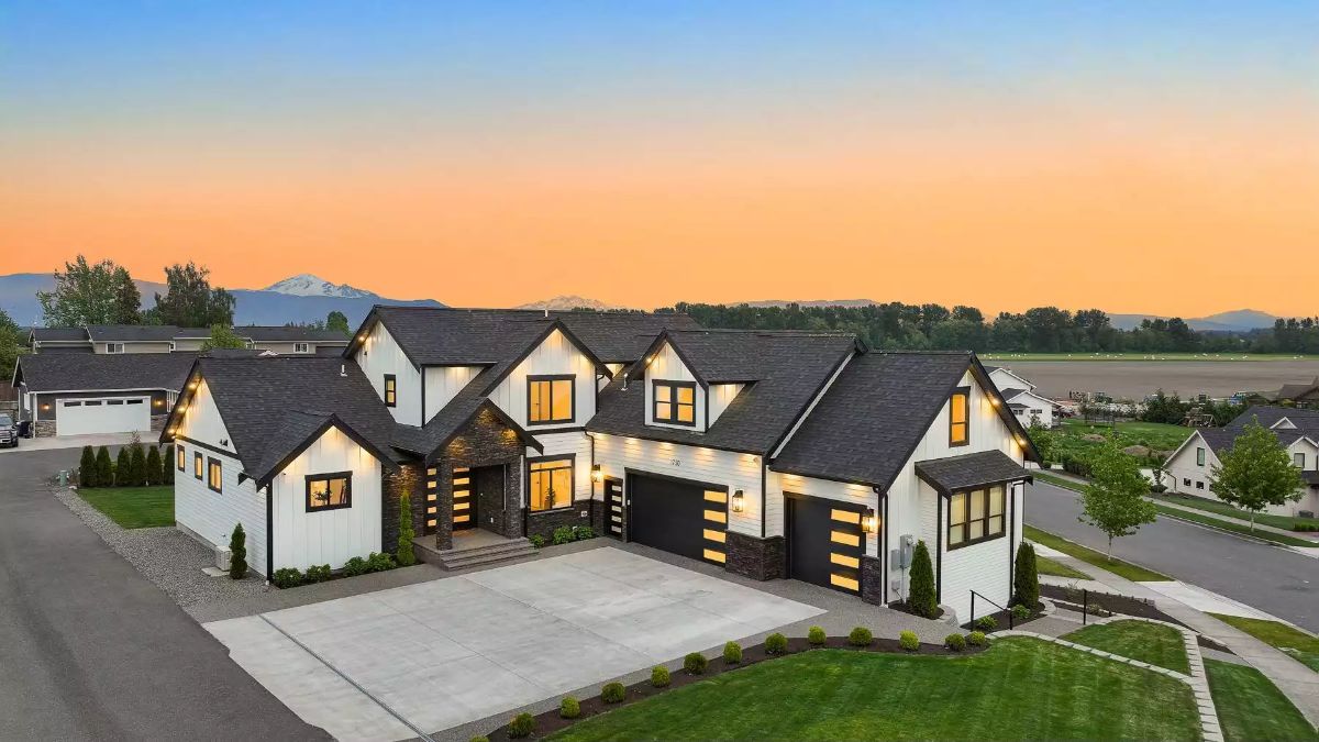 Sunset-Lit Modern Farmhouse With Stone Accents and a Three-Car Garage Worth the Lot Size
