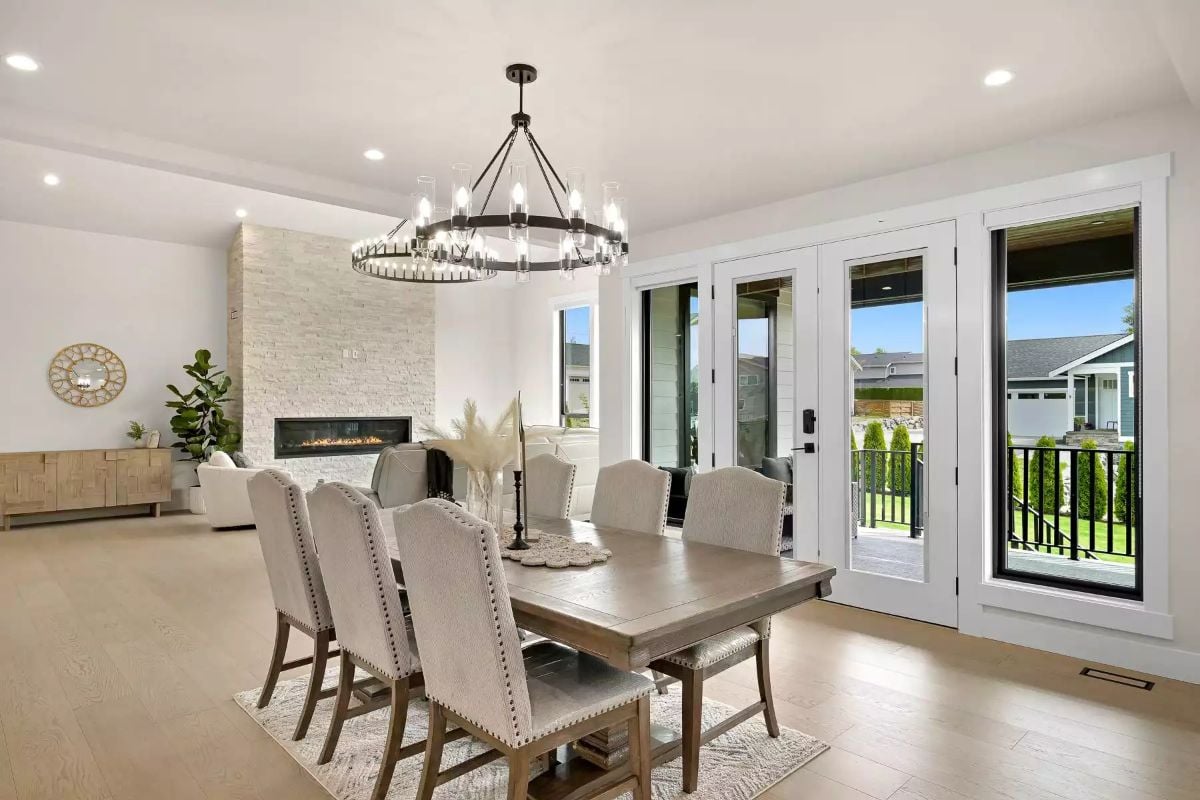 Wagon Wheel Chandelier Anchors a Dining Room Built Around the Fireplace