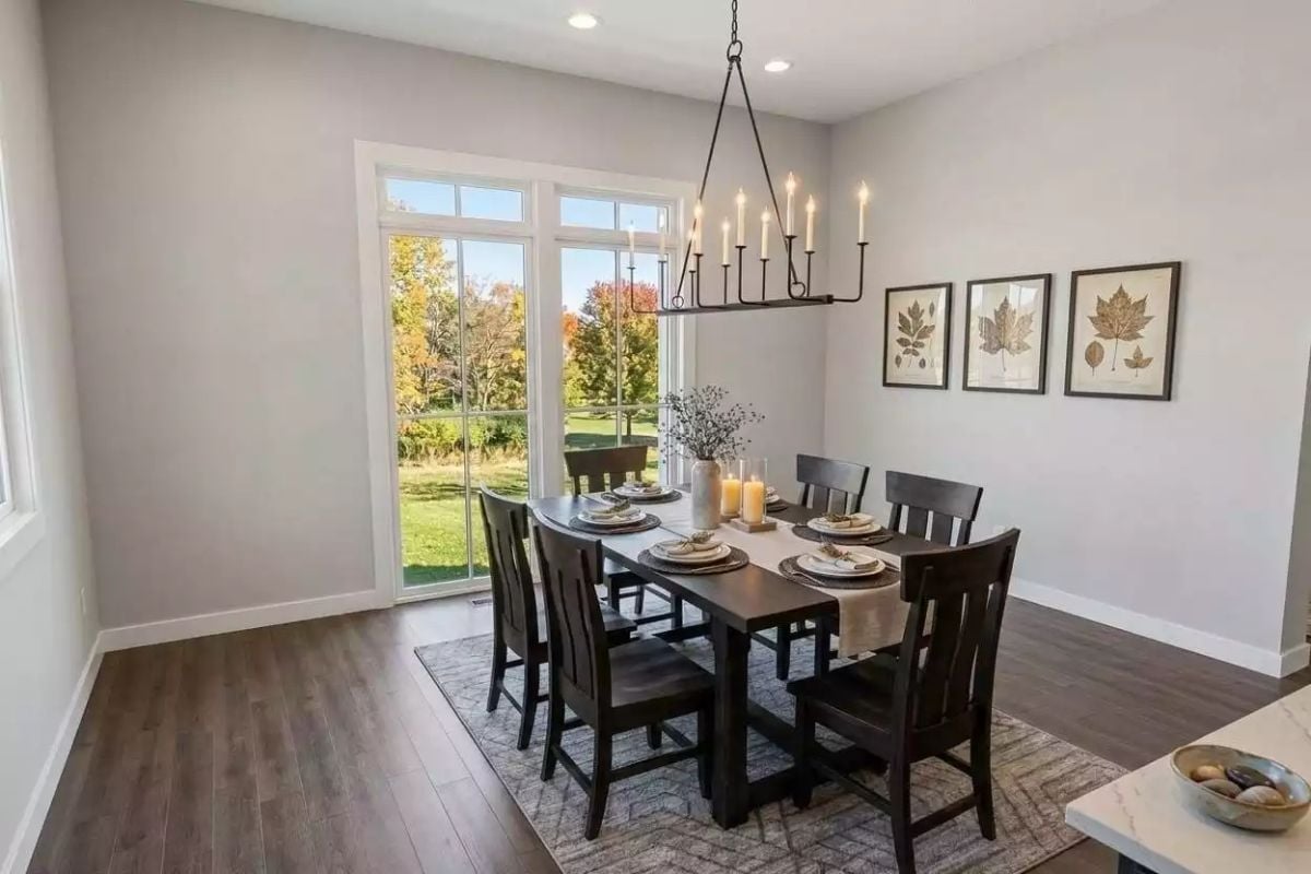 Candle-Style Chandelier Over Dark Wood Sets a Tone Without Trying Too Hard
