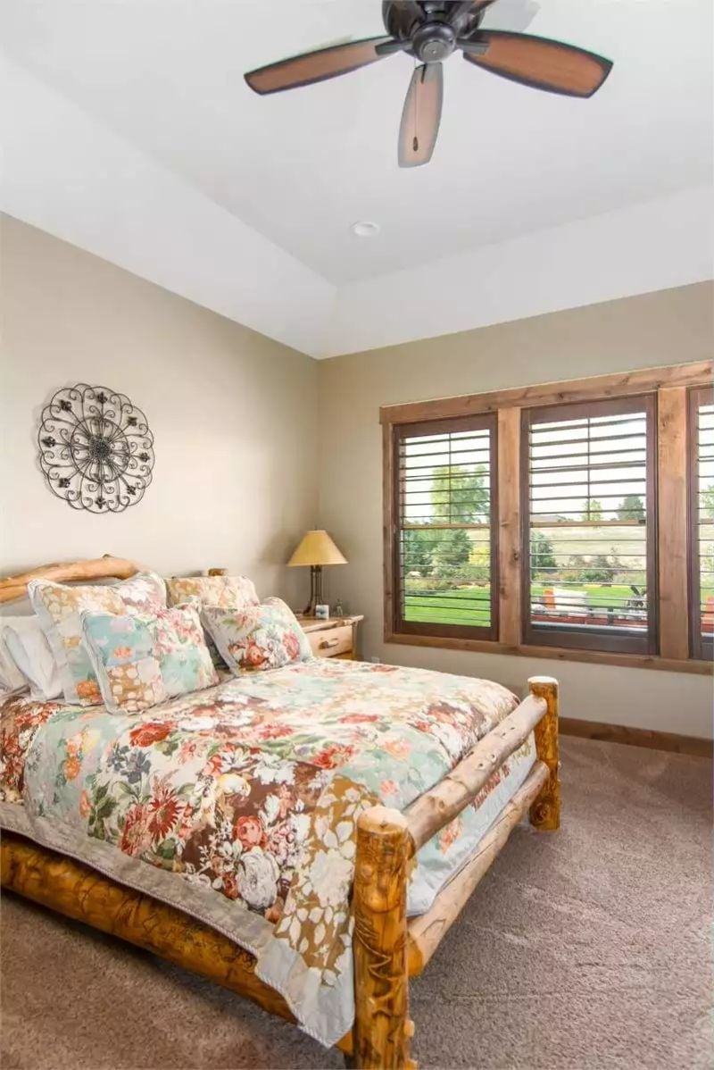 Log Bed Frame and Floral Quilt Pull Off Rustic Without Trying Too Hard