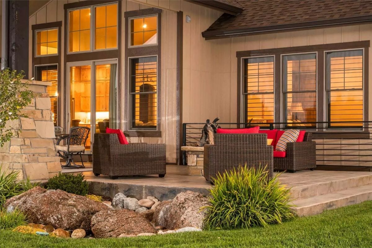 Wicker, Red Cushions, and Stone Steps That Earn Their Place Outside
