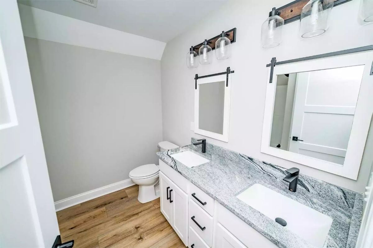 Barn-Style Mirrors and Black Fixtures on a Double Vanity Done Right