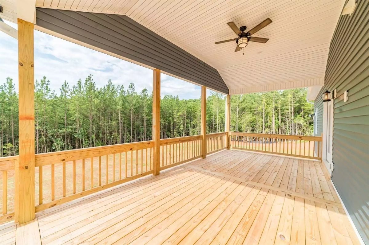 Covered Porch With a Tree Line That Does All the Decorating