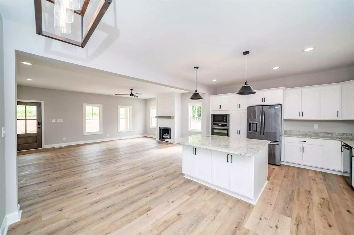 Marble Island, Black Pendants, and an Open Plan That Earns Its Square Footage