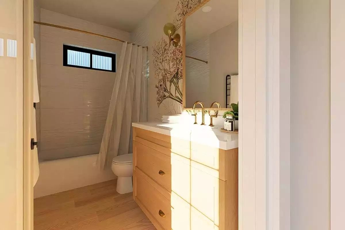 Brass Faucets and Botanical Wallpaper Make a Small Bath Feel Collected, Not Cramped