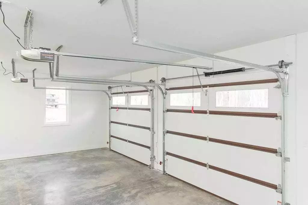 Dual Garage Doors With Torsion Springs and Hormann Openers Ready for Daily Punishment