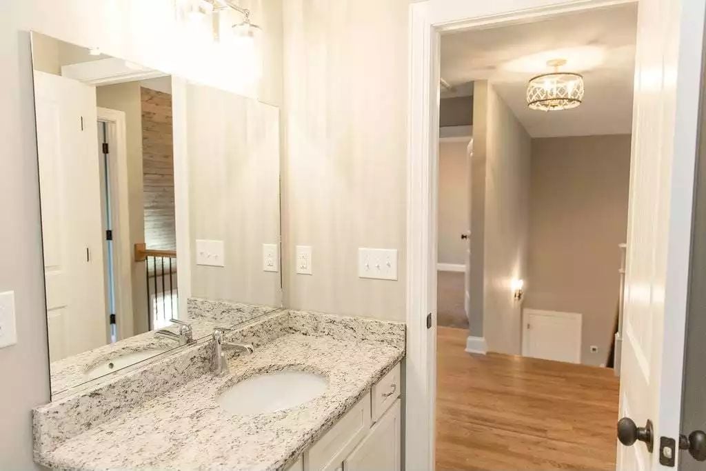 Granite Counters and a Single-Sink Vanity Keep This Jack-and-Jill Bath Practical