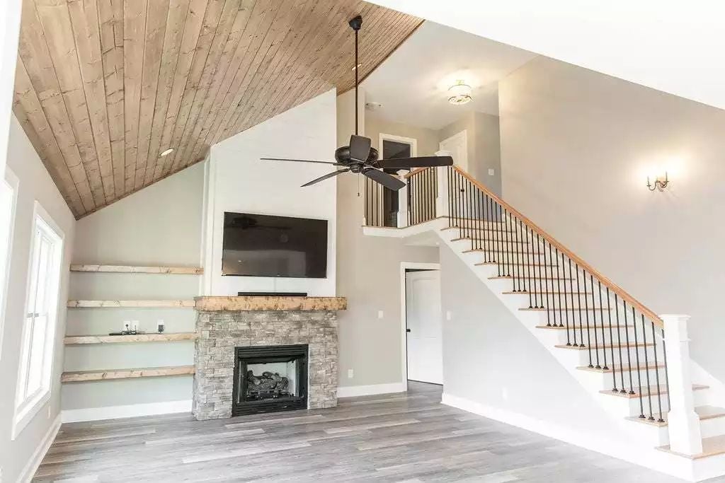Shiplap Ceiling and Stone Fireplace Pull the Whole Room Together