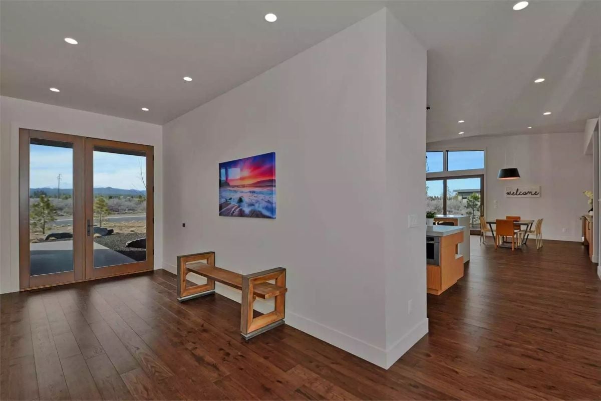 French Doors, Dark Hardwood, and Art That Earns Its Wall