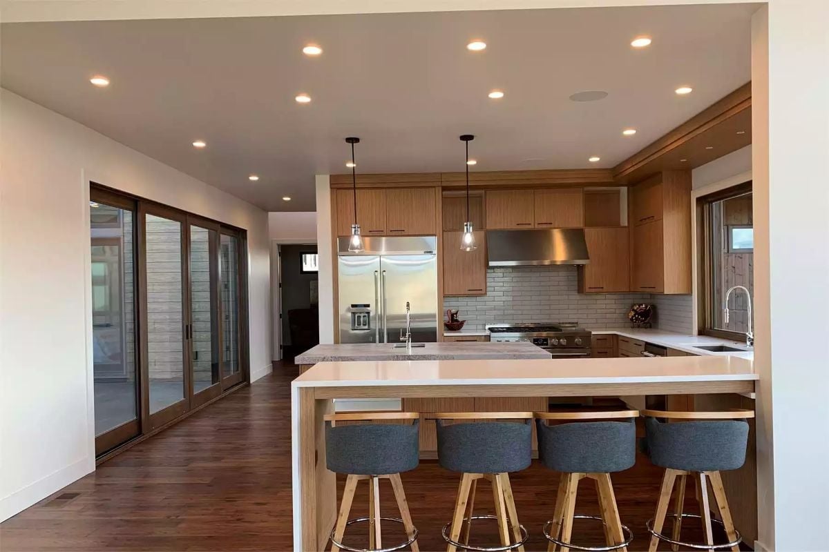 Quartz Island, Oak Cabinets, and Four Stools That Mean Business