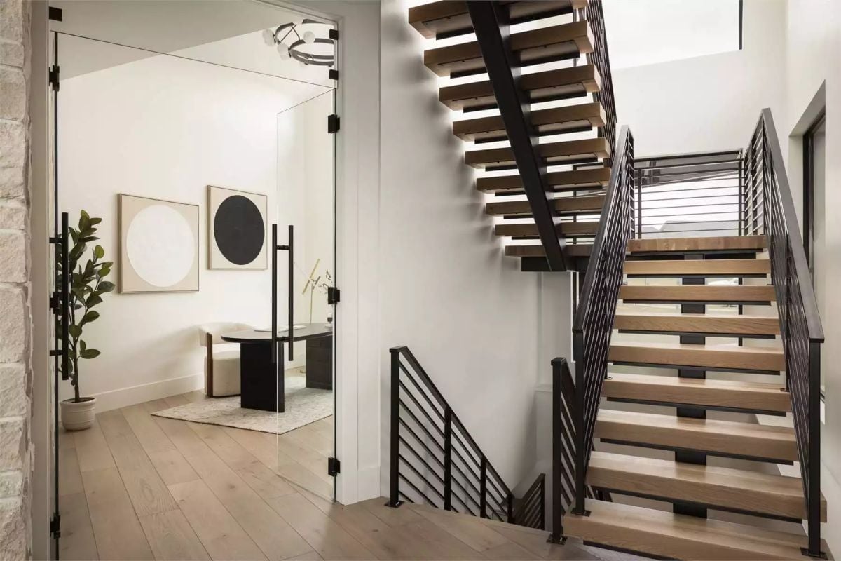Open-Riser Stairs and a Glass-Walled Office That Doesn't Hide Anything