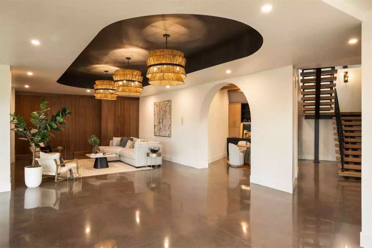 Rattan Pendants and a Dark Ceiling Cutout Make the Living Room Earn Its Square Footage