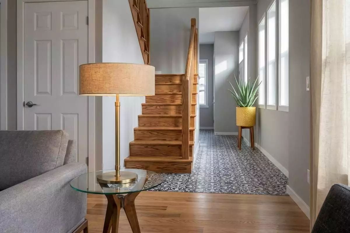 Brass Lamp, Patterned Tile, and a Staircase That Earns Its Keep