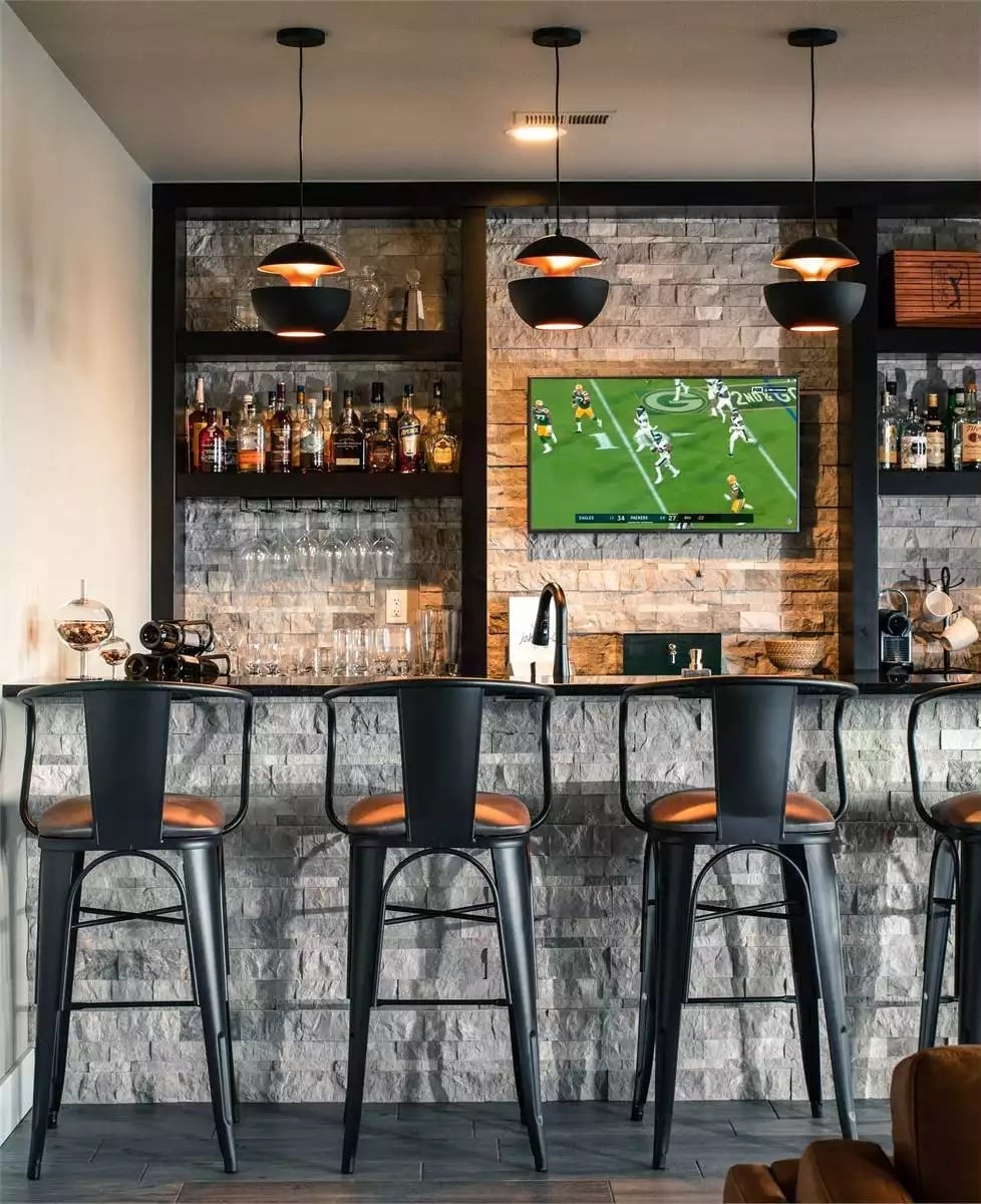 Copper-Backed Pendants Over a Stone Bar That Means Business
