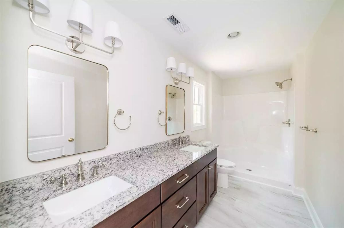 Brushed Nickel Wall Sconces and Granite That Does Most of the Talking