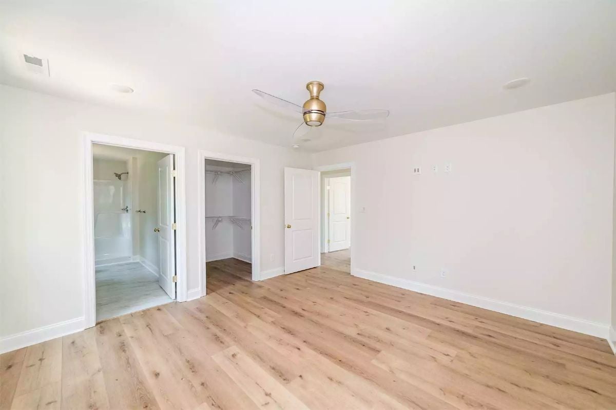 Gold Ceiling Fan, Walk-In Closet, and a Bathroom You Can See From the Doorway