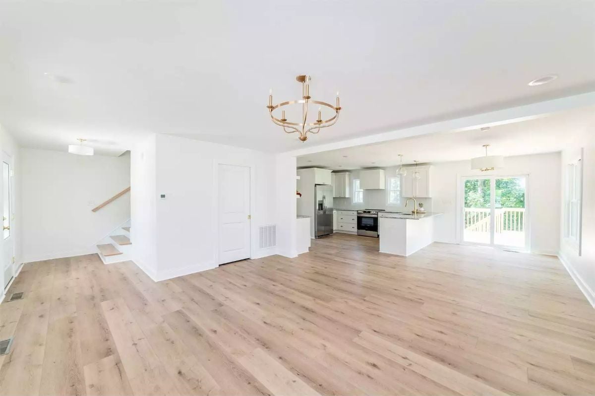 Gold Chandelier, White Cabinets, and Light Wood That Goes All the Way Back
