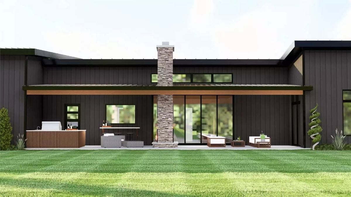 Outdoor Kitchen and Stone Chimney Anchor a Covered Patio Built for Real Use
