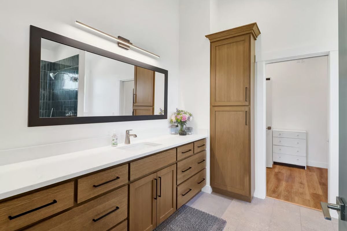 Warm Oak Cabinetry and a White Quartz Counter That Earns Its Keep