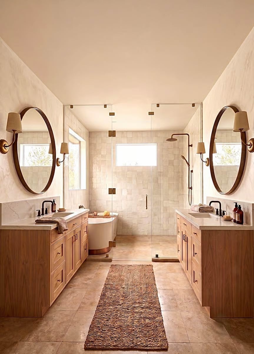 Warm Wood, Oval Mirrors, and a Soaking Tub That Makes the Whole Room Worth It