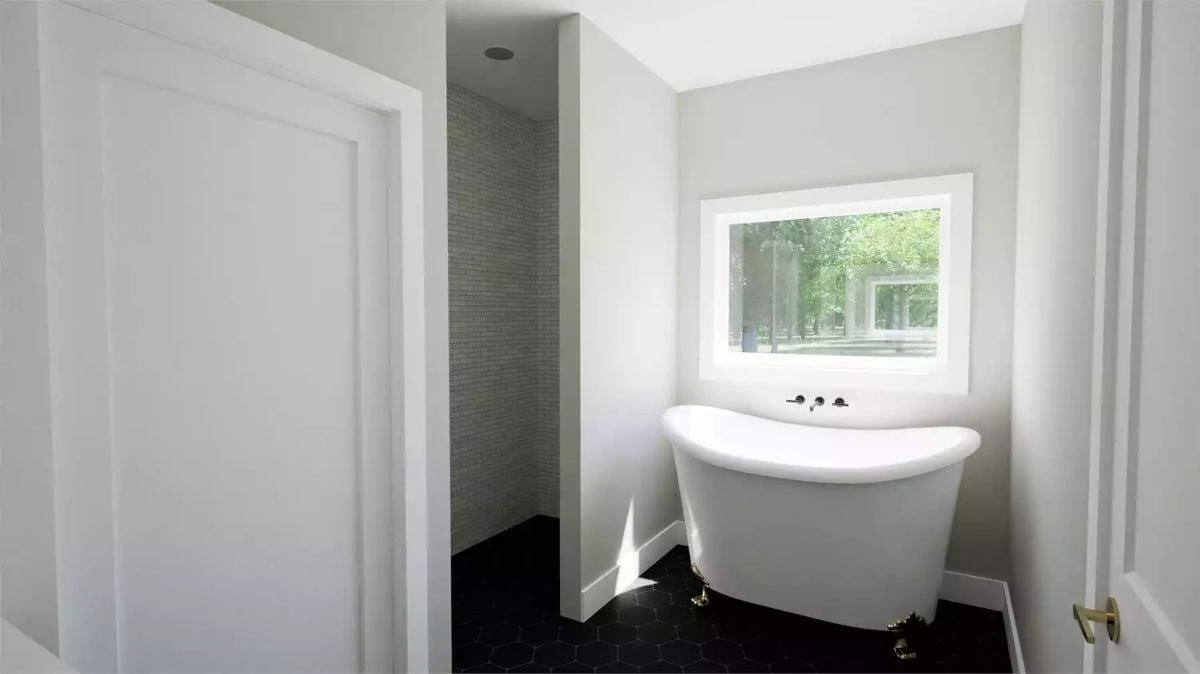 Clawfoot Tub Positioned Under a Window So the View Does Half the Work