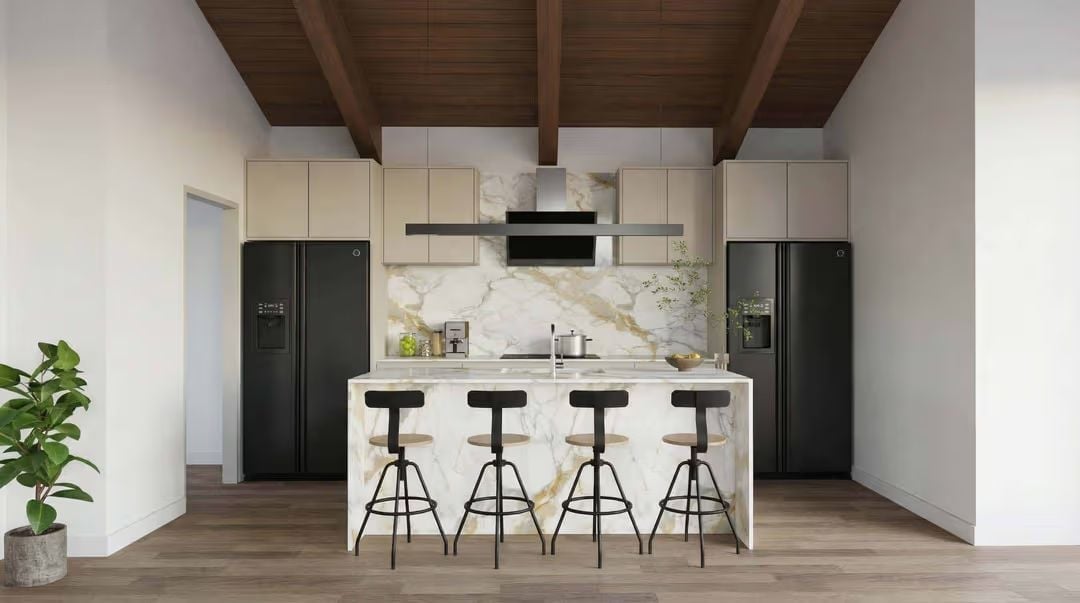 Marble Island, Black Appliances, and Exposed Beams That Anchor the Whole Room