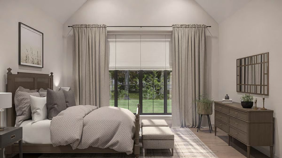 Vaulted Ceiling and Roman Shade Layering Give This Bedroom Quiet Authority