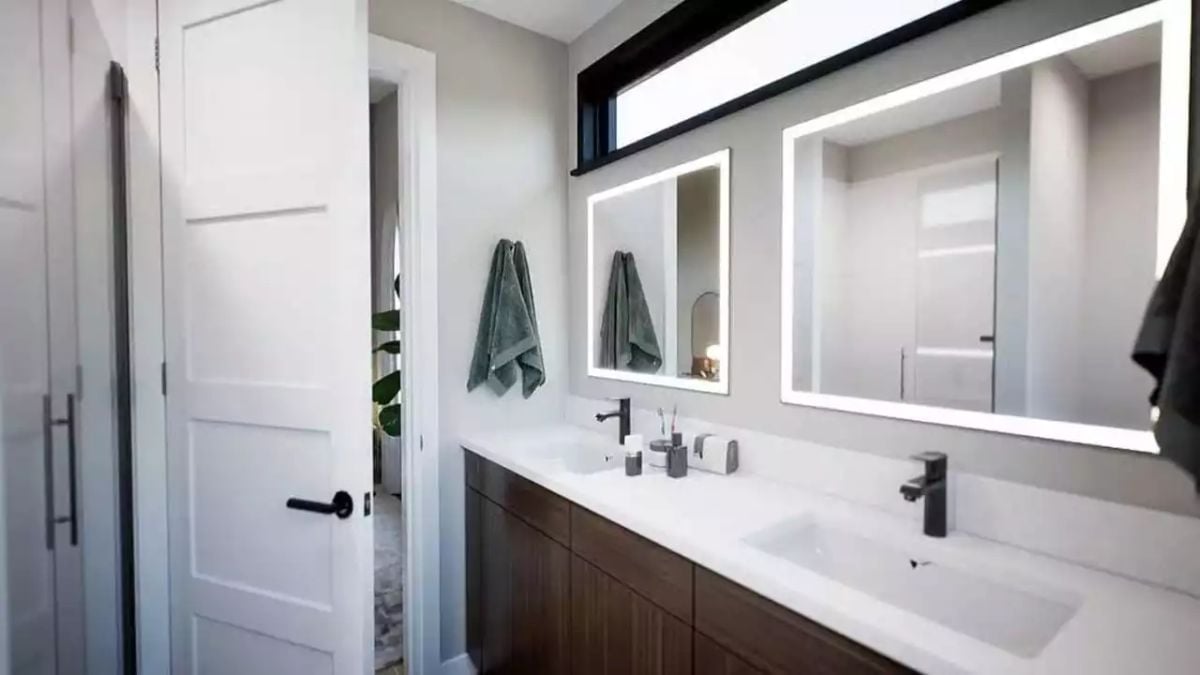 Lighted Mirrors, Matte Black Fixtures, and a Double Vanity That Pulls Its Weight