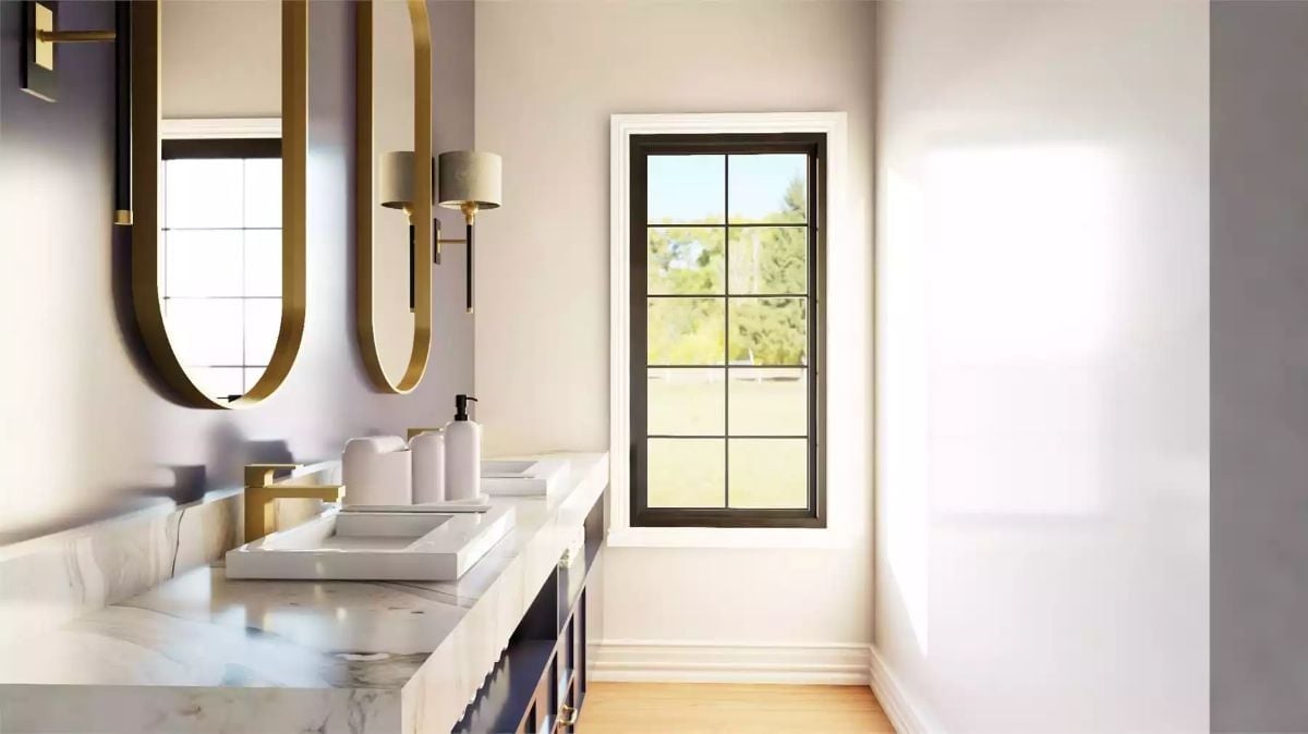 Gold Oval Mirrors and a Marble Vanity Top Set the Tone in This Bathroom