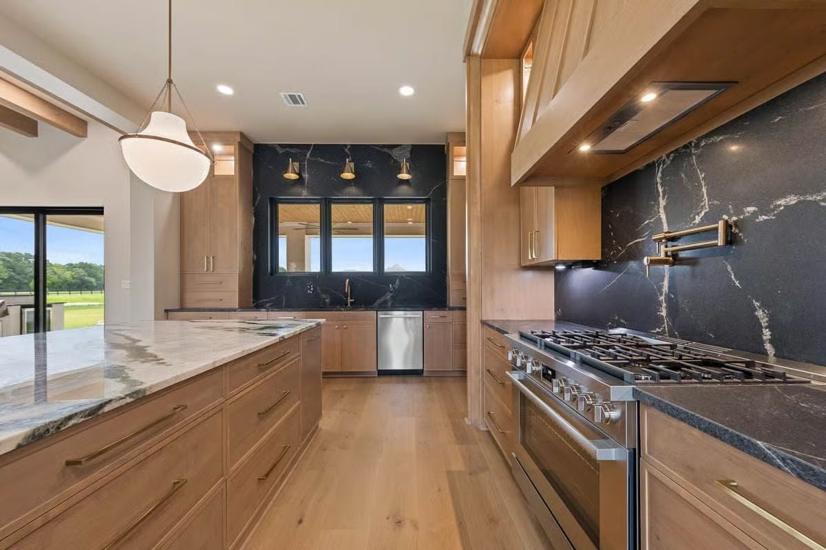 Pot Filler, Black Marble Slab, and a Range That Means Business