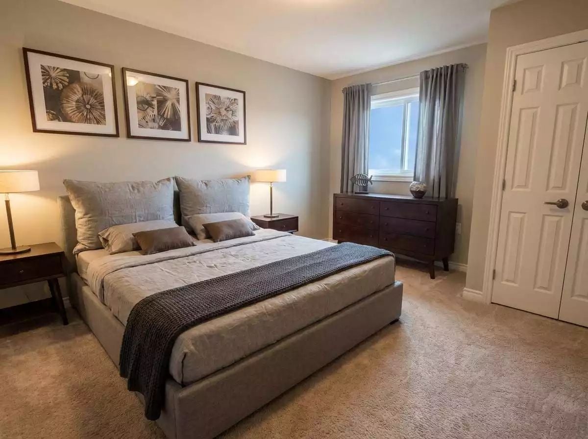 Warm Neutrals and Dark Wood Make This Bedroom Feel Like a Resort Retreat