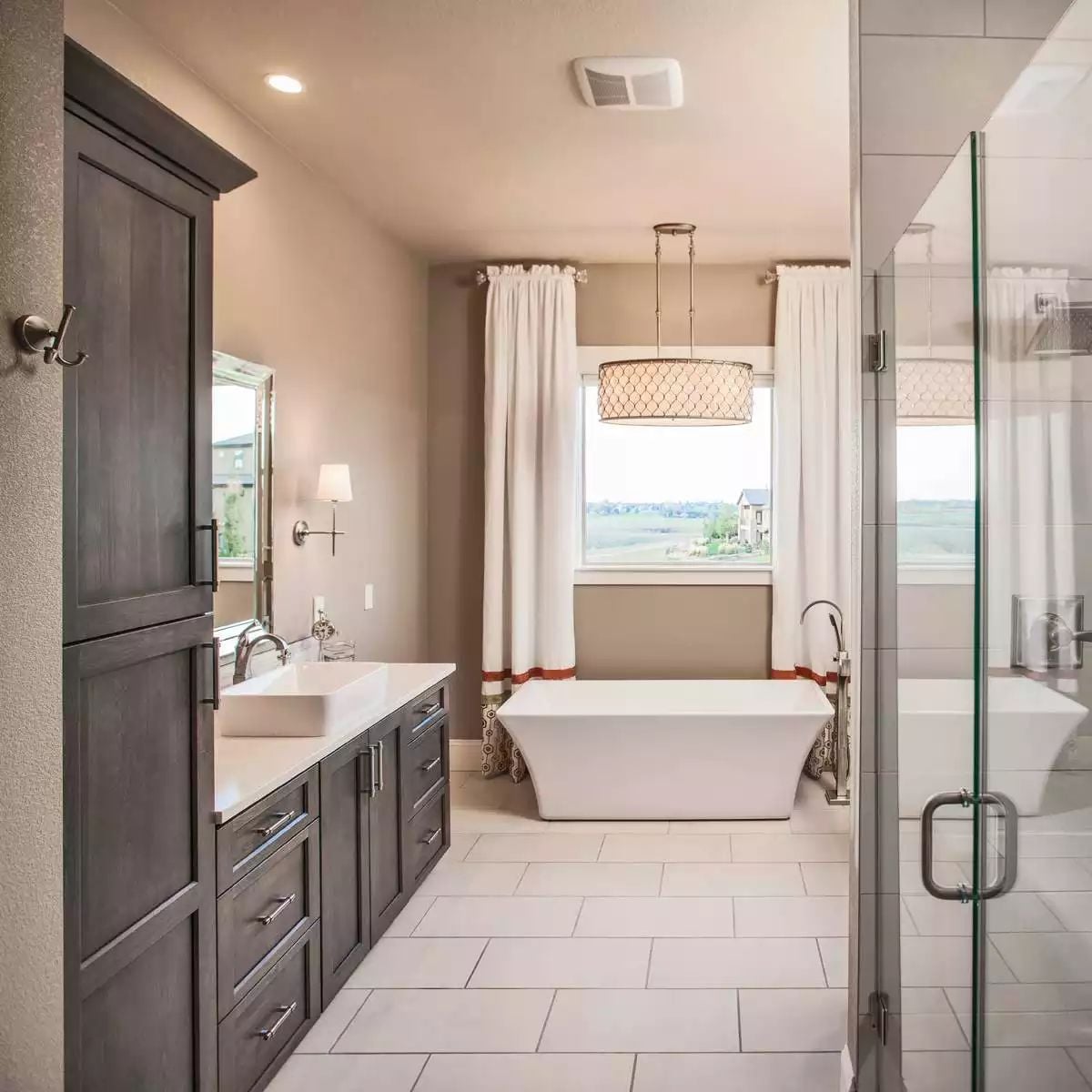 Freestanding Tub Centered Under a Drum Pendant That Actually Fits the Space