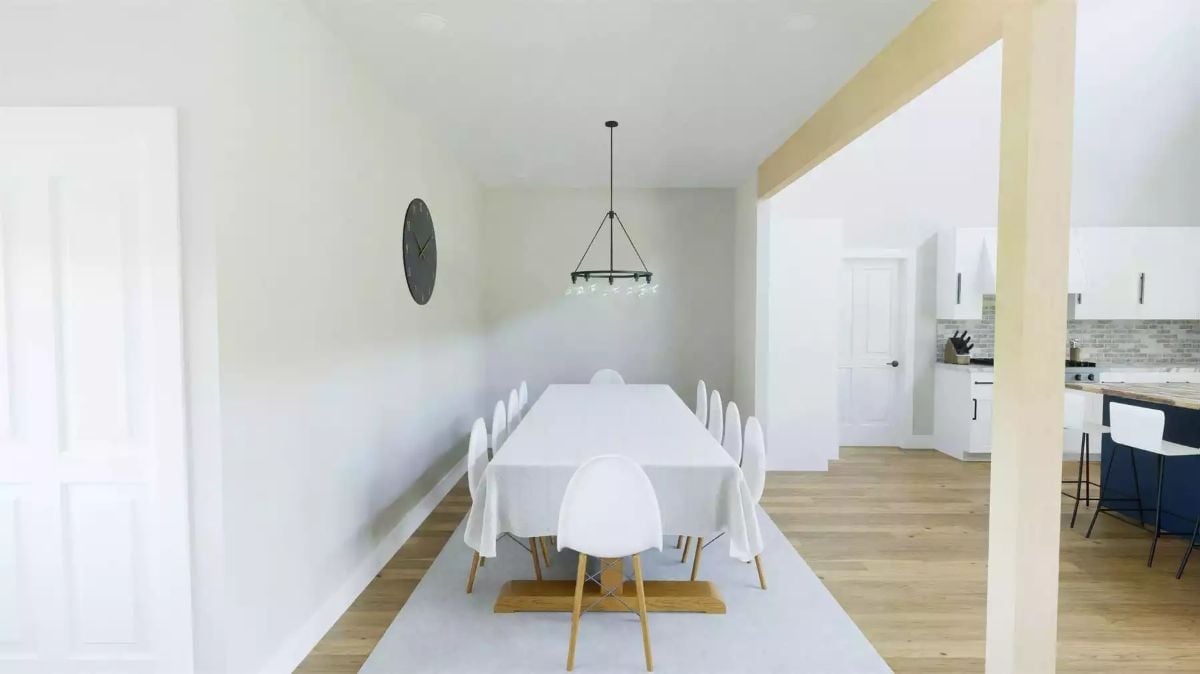 Long Table, White Chairs, and a Chandelier That Earns Its Place Above Both