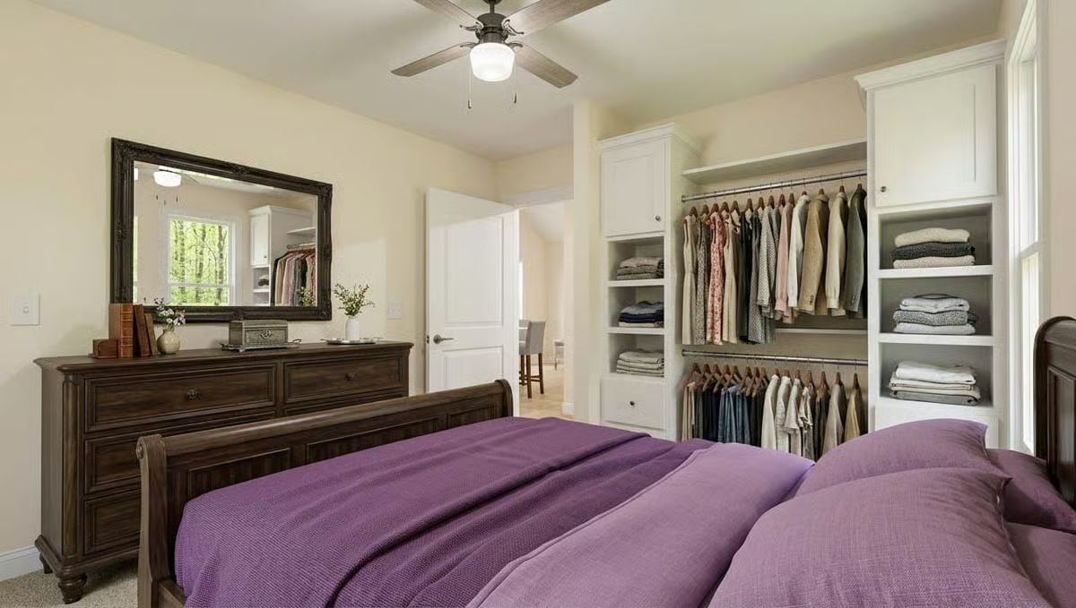 Purple Bedding Against Dark Wood Furniture Gives This Primary Bedroom Real Personality