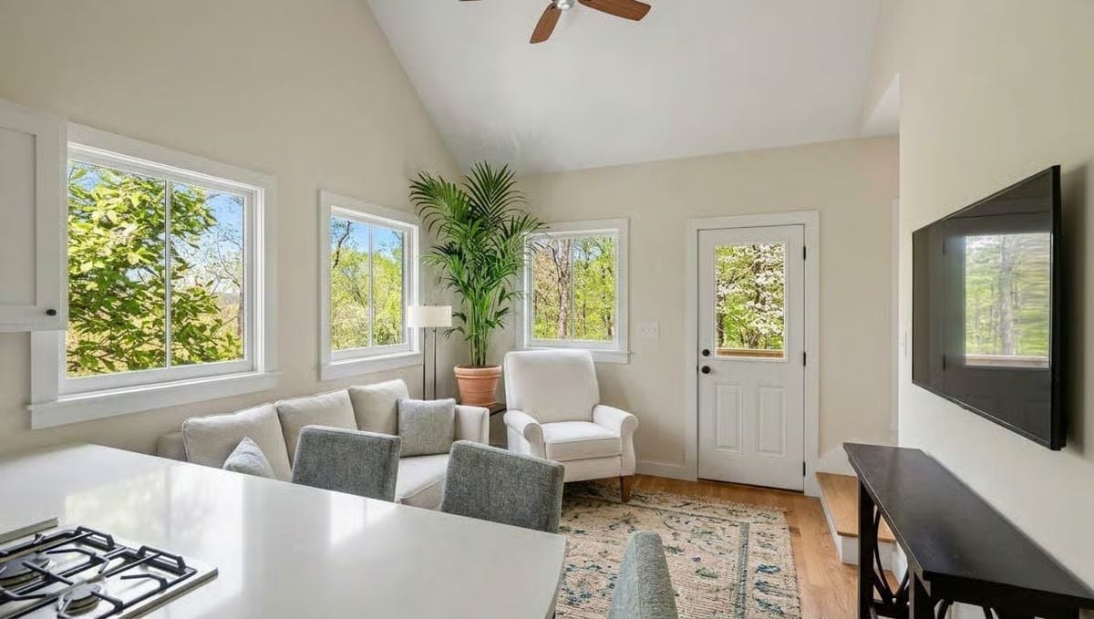 Vaulted Ceilings and Wraparound Windows Pull the Treeline Right Into the Room