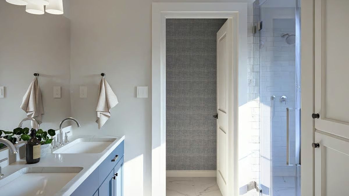 Blue Vanity, Glass Shower, and a Water Closet Door That Pulls the Eye Straight Back