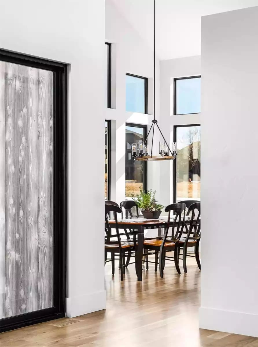 Reclaimed Wood Slider, Black Chandelier, and Dining Chairs That Mean Business