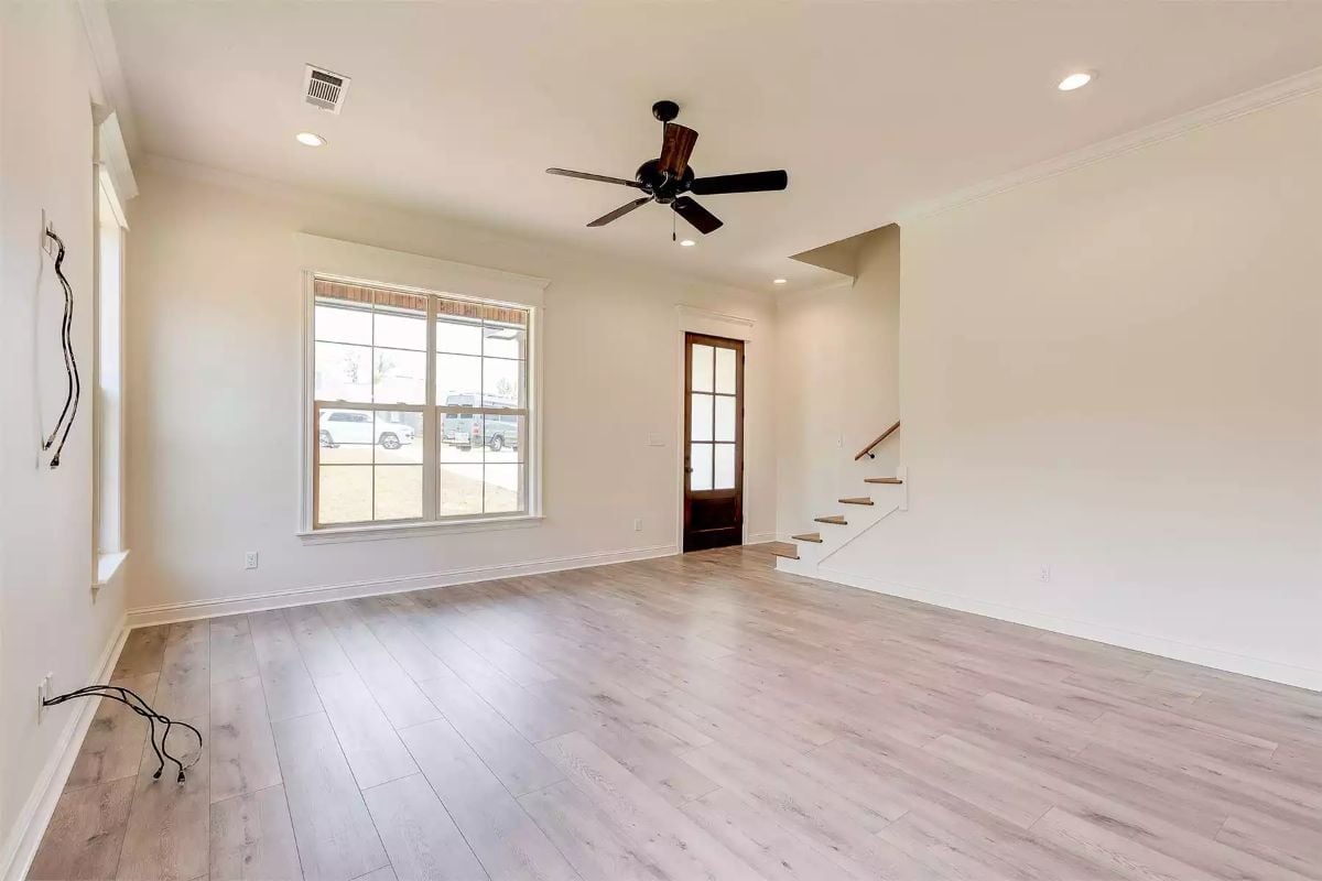 Dark Ceiling Fan Against White Trim Keeps This Living Room Grounded