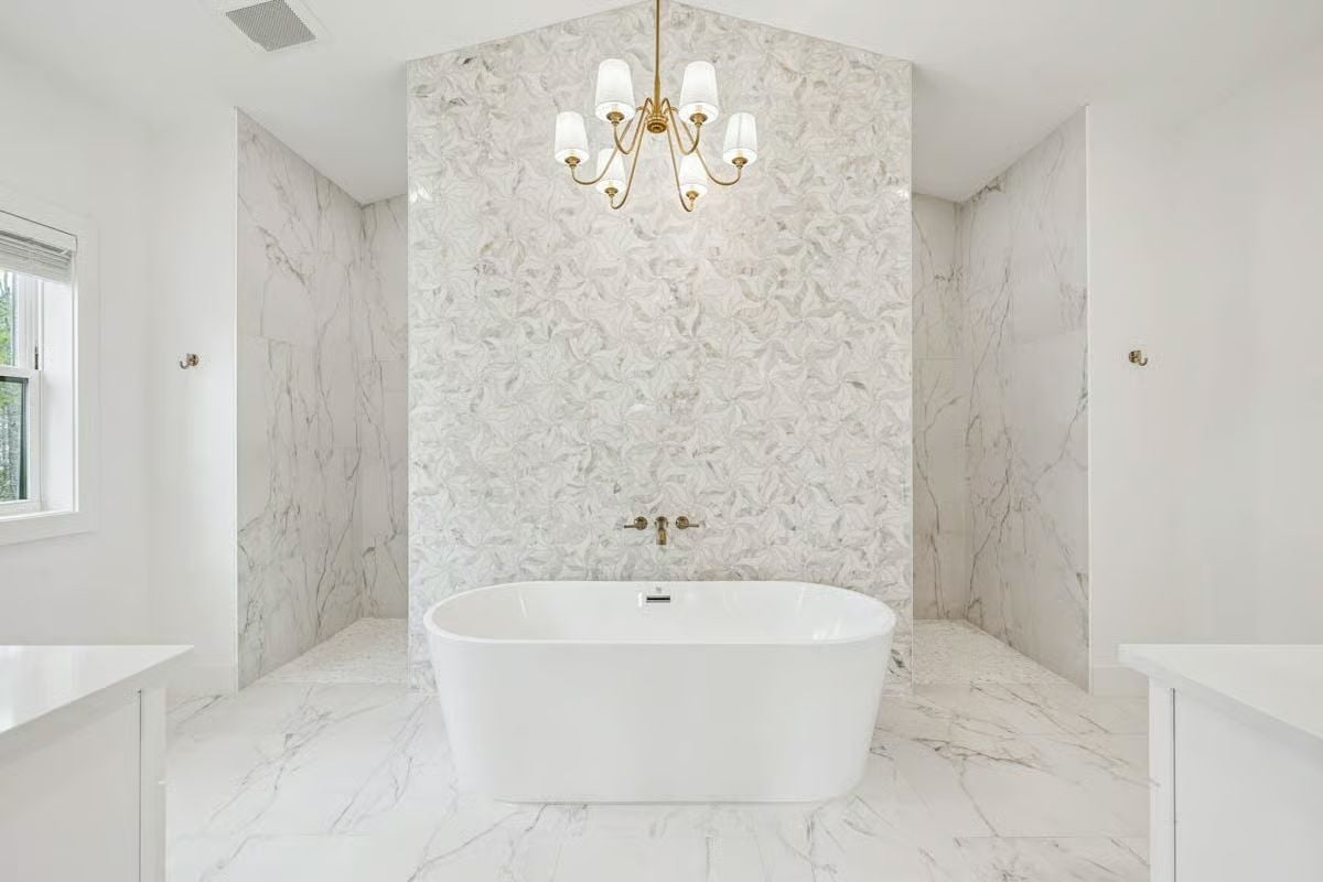 Mosaic Accent Wall and Gold Chandelier Turn a Soaking Tub Into a Destination