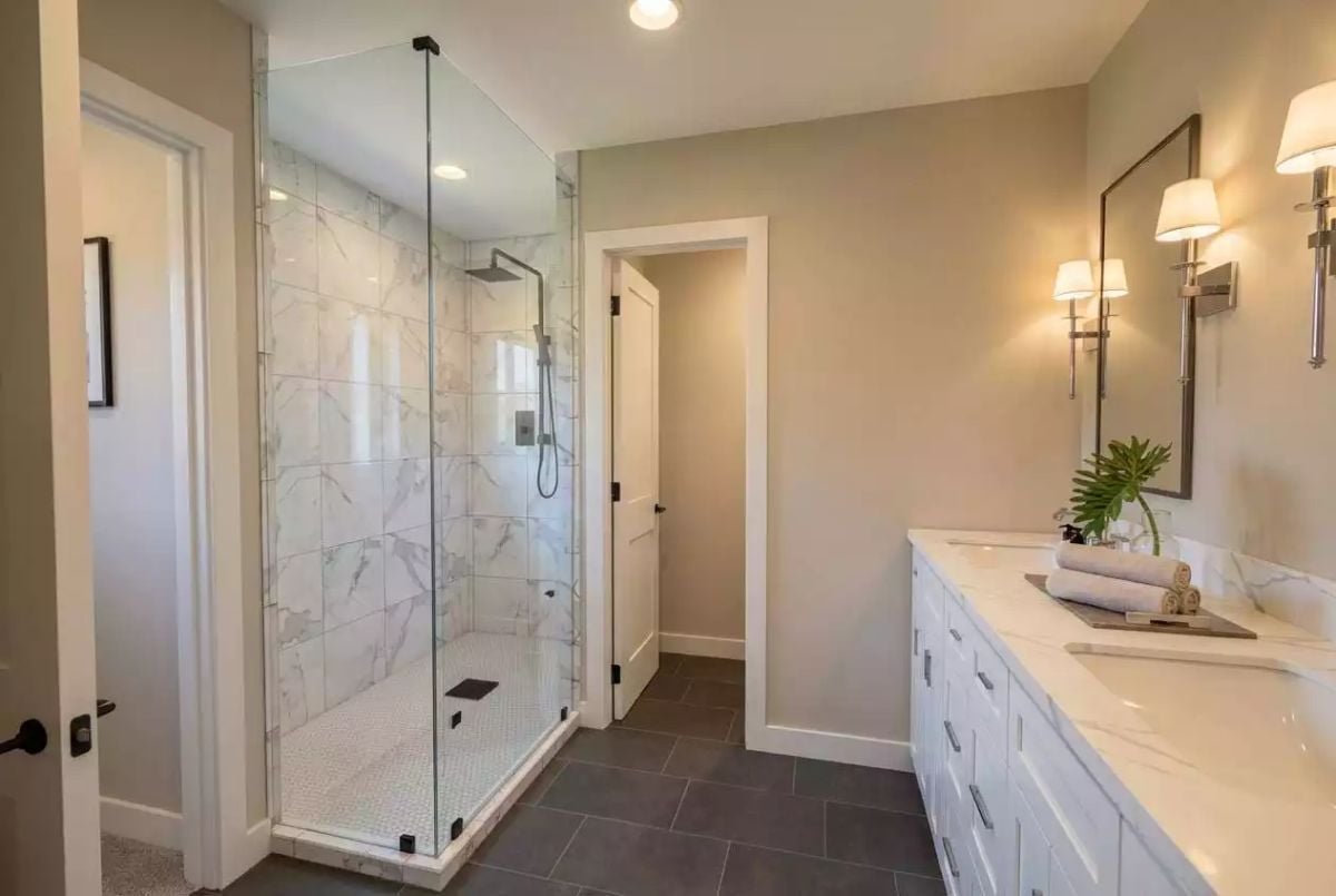 Marble Shower Tile, Glass Enclosure, and a Vanity Long Enough to Share