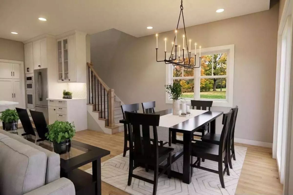 Candle-Style Chandelier Over a Dark Dining Set Pulls the Whole Open Plan Together