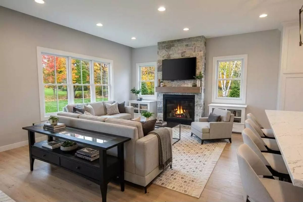 Stone Fireplace Surround Running Floor to Ceiling Earns Every Inch of Wall Space