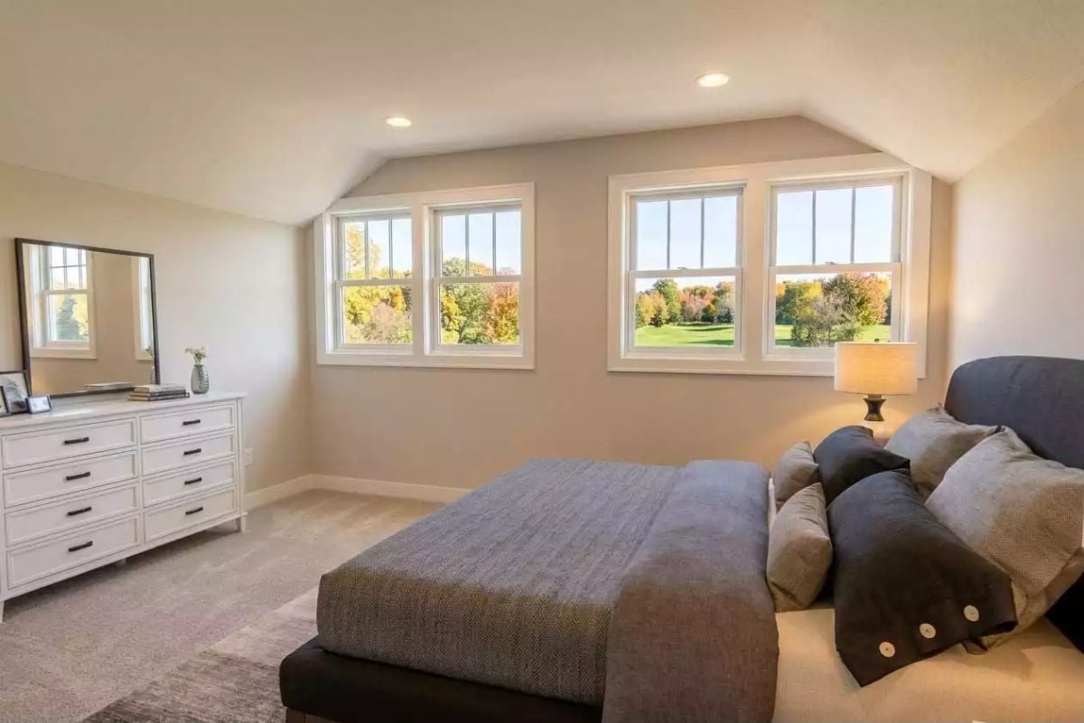 Vaulted Ceiling and Four Windows Give This Bedroom Views Worth Waking Up For