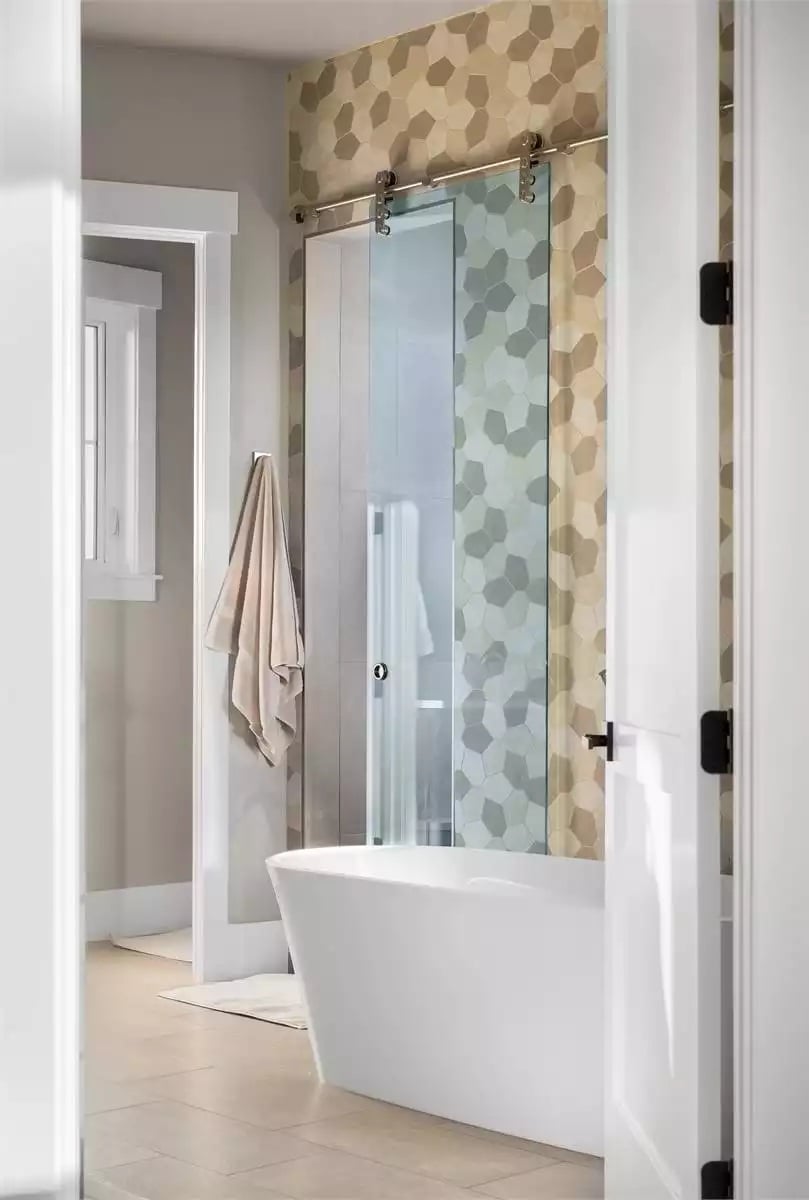 Barn-Style Glass Door, Freestanding Tub, and Hex Tile That Pulls It Together